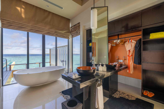 Angsana Velavaru, Dhaalu Atoll — InOcean villa bathroom with a freestanding bath beside full-height windows
