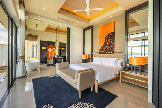Angsana Velavaru, Dhaalu Atoll — InOcean villa bedroom with the bath beyond and doors onto the deck