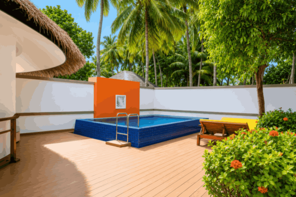 Angsana Velavaru, Dhaalu Atoll — the pool deck of the two-bedroom pool villa, with an orange feature panel and a bench
