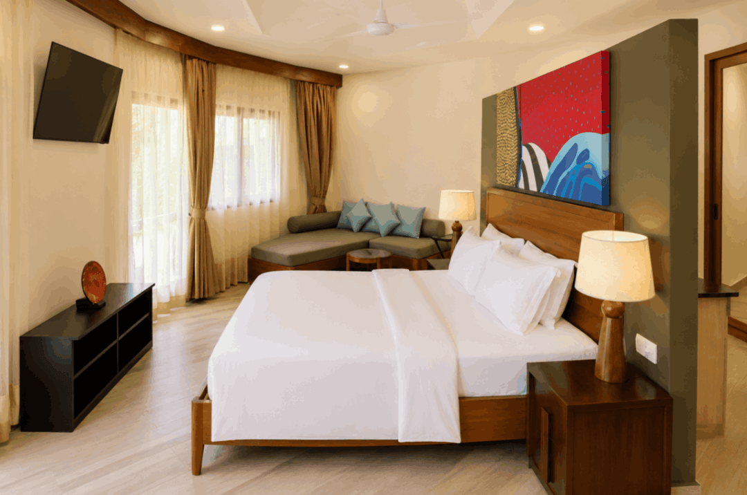 Angsana Velavaru, Dhaalu Atoll — two-bedroom pool villa bedroom with a sofa and a television