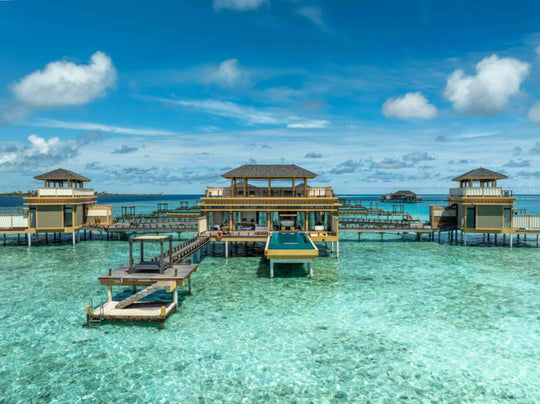 Angsana Velavaru, Dhaalu Atoll — Deluxe InOcean villas seen from the lagoon, each on stilts with its own deck
