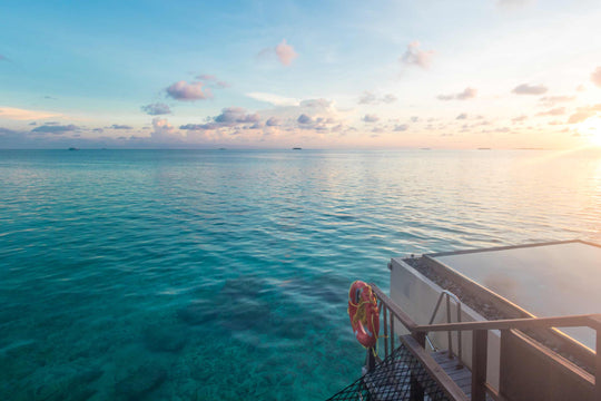Sunset over the lagoon seen from a suite deck at Ayada Maldives