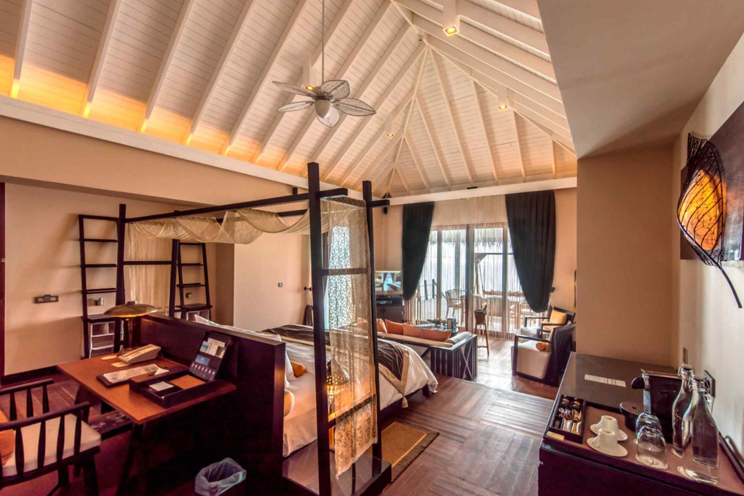 The upper level of a two storey lagoon suite at Ayada Maldives, stairs leading down