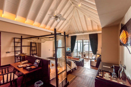 The upper level of a two storey lagoon suite at Ayada Maldives, stairs leading down