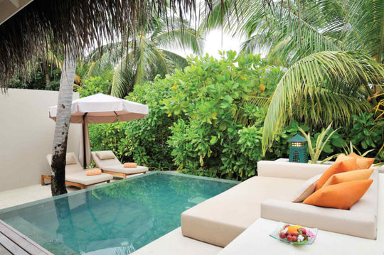 The private pool of a Beach Villa at Ayada Maldives, daybed and loungers under the palms