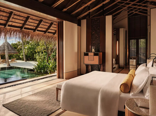 One&amp;Only Reethi Rah Beach Villa with Pool, bedroom doors folded back onto the private infinity pool and thatched sun shade