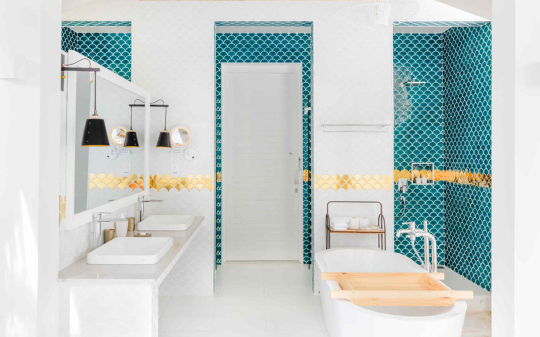 Sun Siyam Iru Veli, Dhaalu Atoll — bathroom in teal fish-scale tiling with twin basins and a freestanding tub