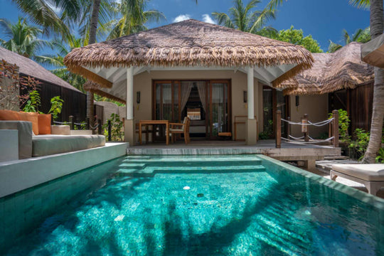 A family beach villa at Ayada Maldives, private pool and two hanging chairs under the thatch