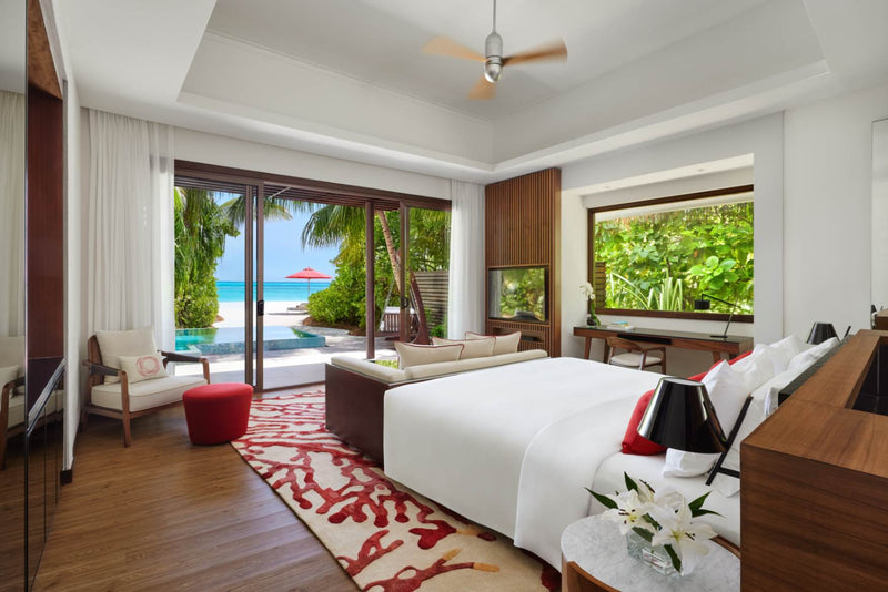 Bed and seating area in a Beach Pool Villa at Niyama Private Islands