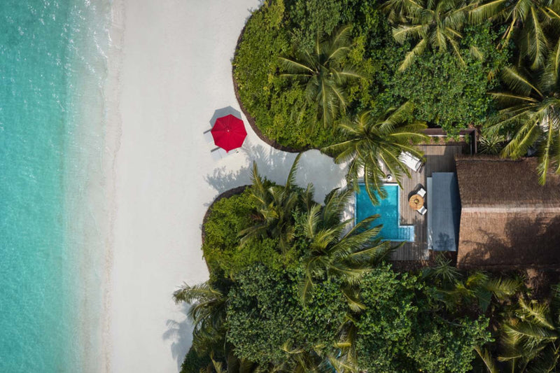 Beach Pool Villa at Niyama Private Islands seen from the air, set among palms behind the sand