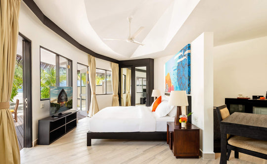 Angsana Velavaru, Dhaalu Atoll — the same beachfront villa bedroom, king bed facing the garden doors