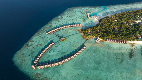 The island of Ayada Maldives with its overwater villas sweeping out over the reef