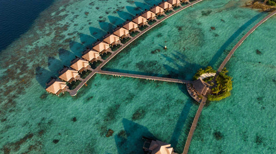 The overwater villas at Ayada Maldives from above, each with its own deck and plunge pool