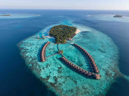 An aerial of Ayada Maldives, the overwater villas and the reef ringing the island
