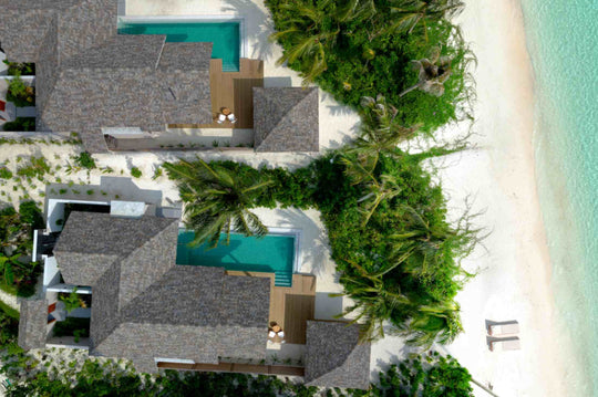 Beach villas at ananea Madivaru Maldives from the air, private pools set back from the sand among coconut palms
