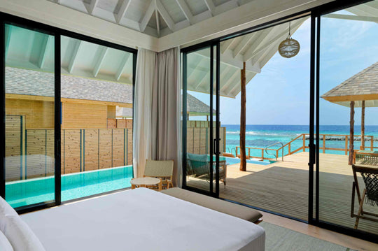 A Deluxe Water Pool Villa at ananea Madivaru Maldives seen from inside, the private pool running along the deck