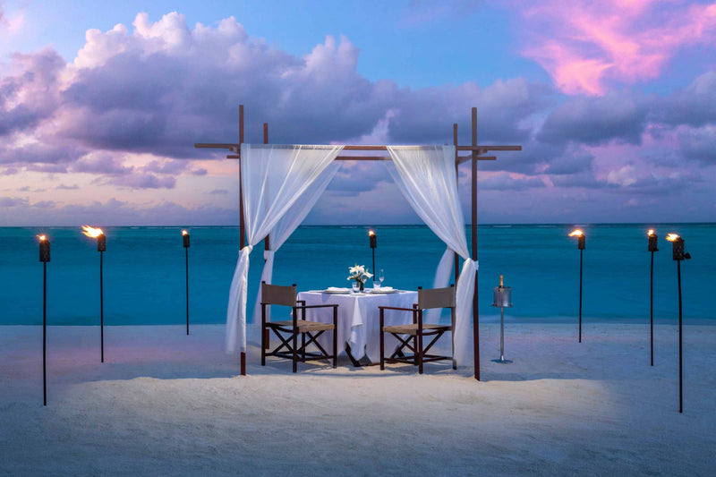 Private destination dining set up beside the water at Niyama Private Islands