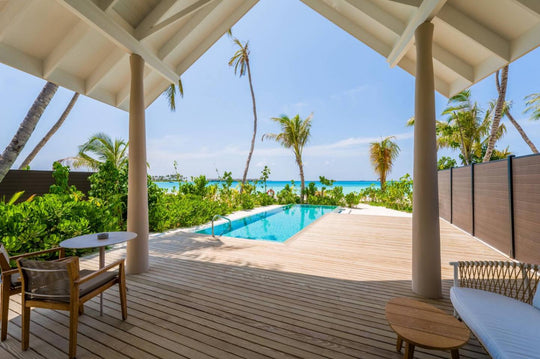 The timber terrace of a beach villa at ananea Madivaru Maldives between the pool and the sea