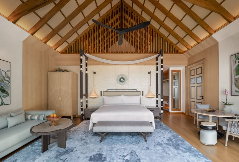 A Beach Pool Villa bedroom at JW Marriott Maldives seen from the deck looking in