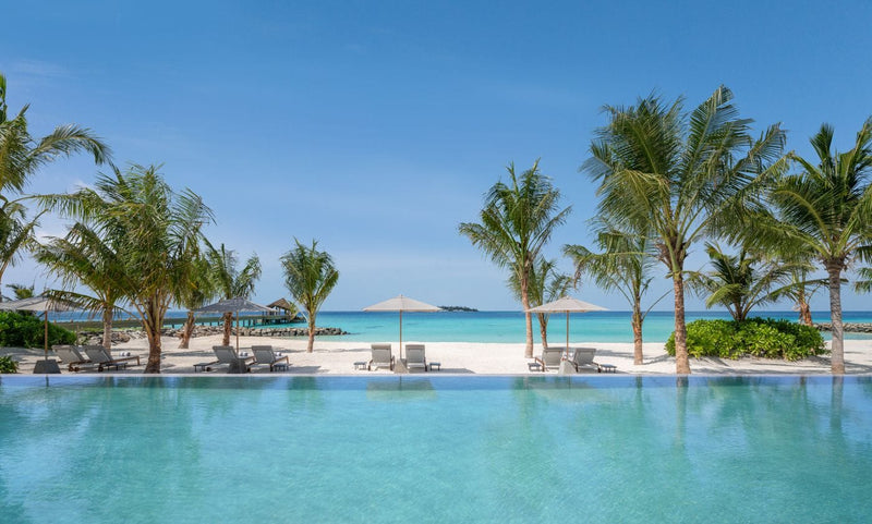 Infinity pool looking out to the beach and lagoon at JW Marriott Maldives Kaafu Atoll Island Resort