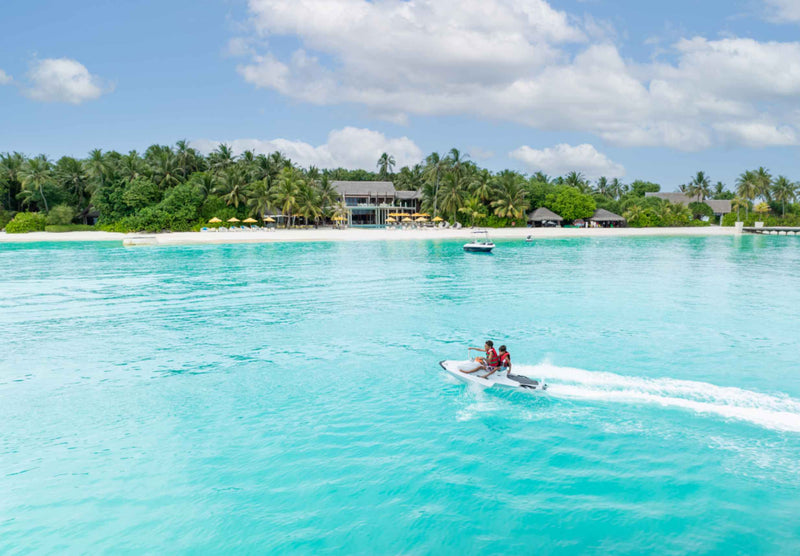 Children riding a jet ski in the lagoon at Niyama Private Islands