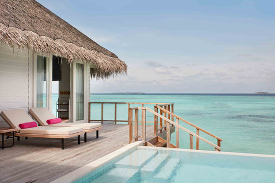 Sun Siyam Iru Veli, Dhaalu Atoll — overwater villa deck at the lagoon edge, loungers beside the private pool