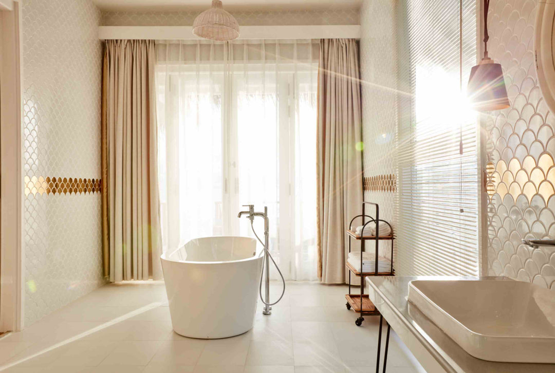 Sun Siyam Iru Veli, Dhaalu Atoll — bathroom with a freestanding tub in full sunlight beside a twin basin