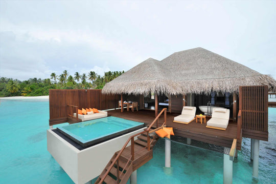 An Ocean Villa at Ayada Maldives standing over the lagoon, private plunge pool and steps down to the water