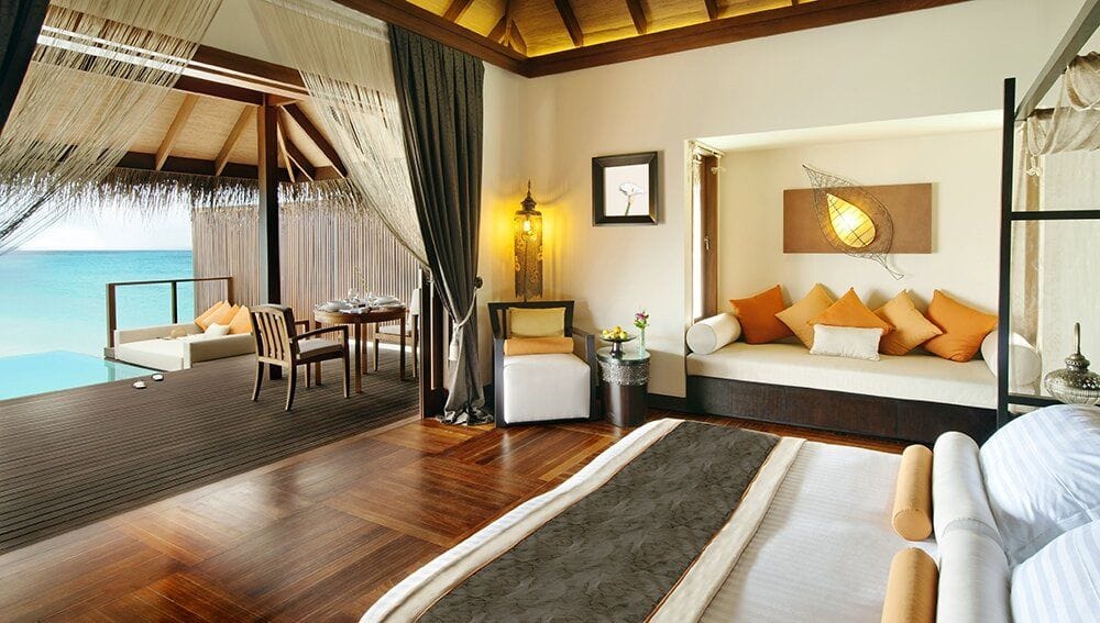 An Ocean Villa bedroom at Ayada Maldives looking out across the water through open doors