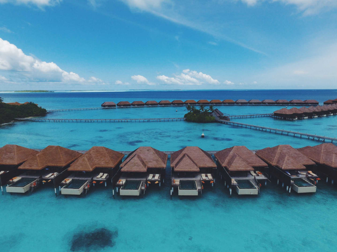 The line of overwater villas at Ayada Maldives seen across the lagoon from the water