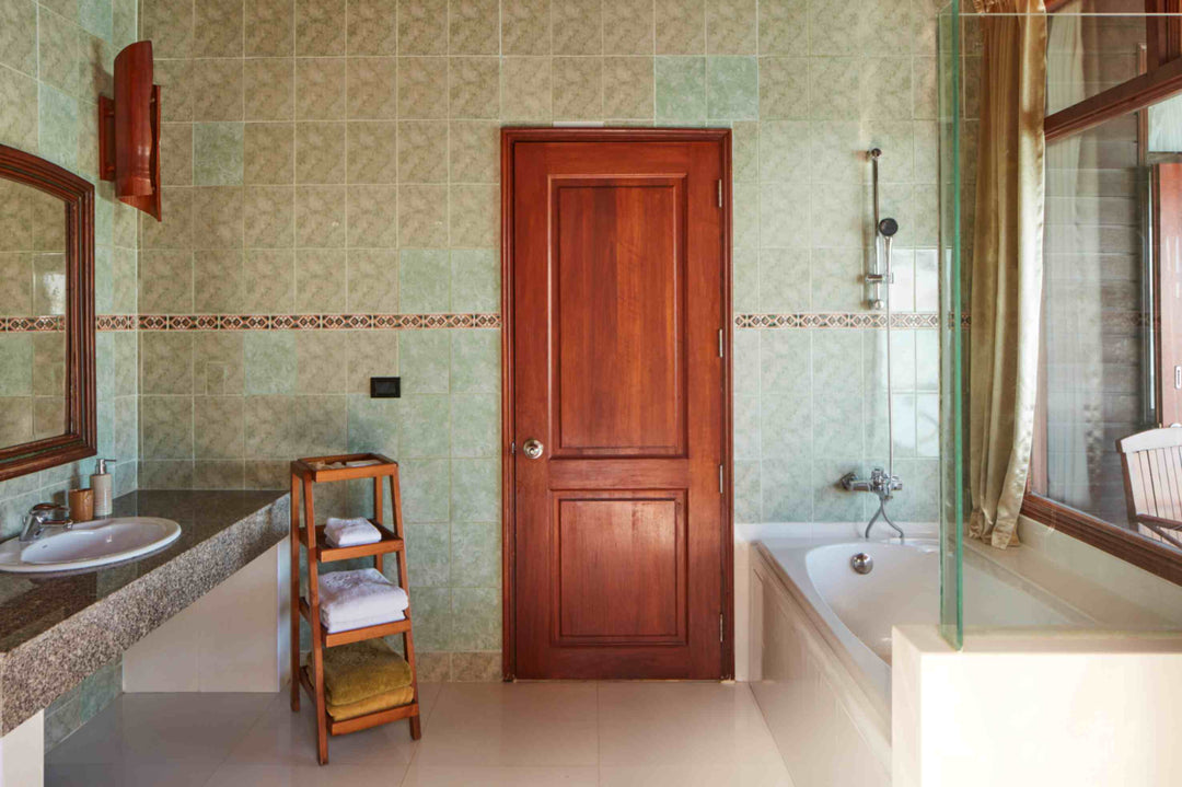 Sun Siyam Olhuveli, South Malé Atoll — water villa bathroom with green patterned tiling and a bath