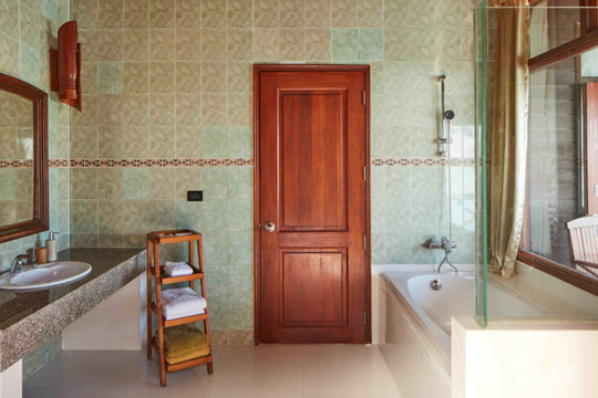 Sun Siyam Olhuveli, South Malé Atoll — water villa bathroom with green patterned tiling and a bath