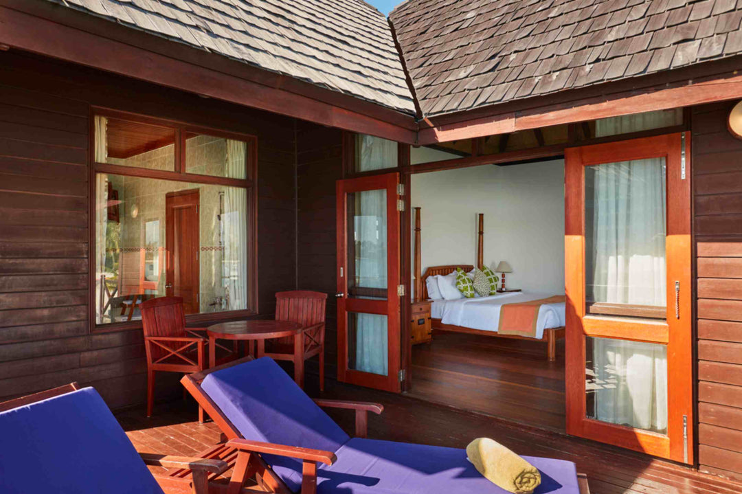 Sun Siyam Olhuveli, South Malé Atoll — water villa deck with sun loungers outside the open doors