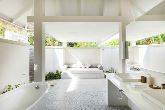 Sun Siyam Olhuveli, South Malé Atoll — Grand Beach Suite bathroom with a freestanding bath and twin basins