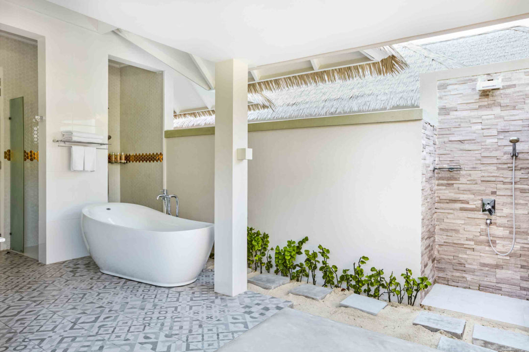 Sun Siyam Olhuveli, South Malé Atoll — suite bathroom with a bath and an open-air shower court