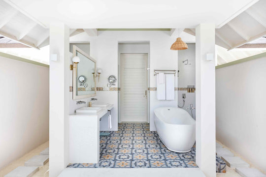 Sun Siyam Olhuveli, South Malé Atoll — bathroom with patterned floor tiles, a freestanding bath and twin basins