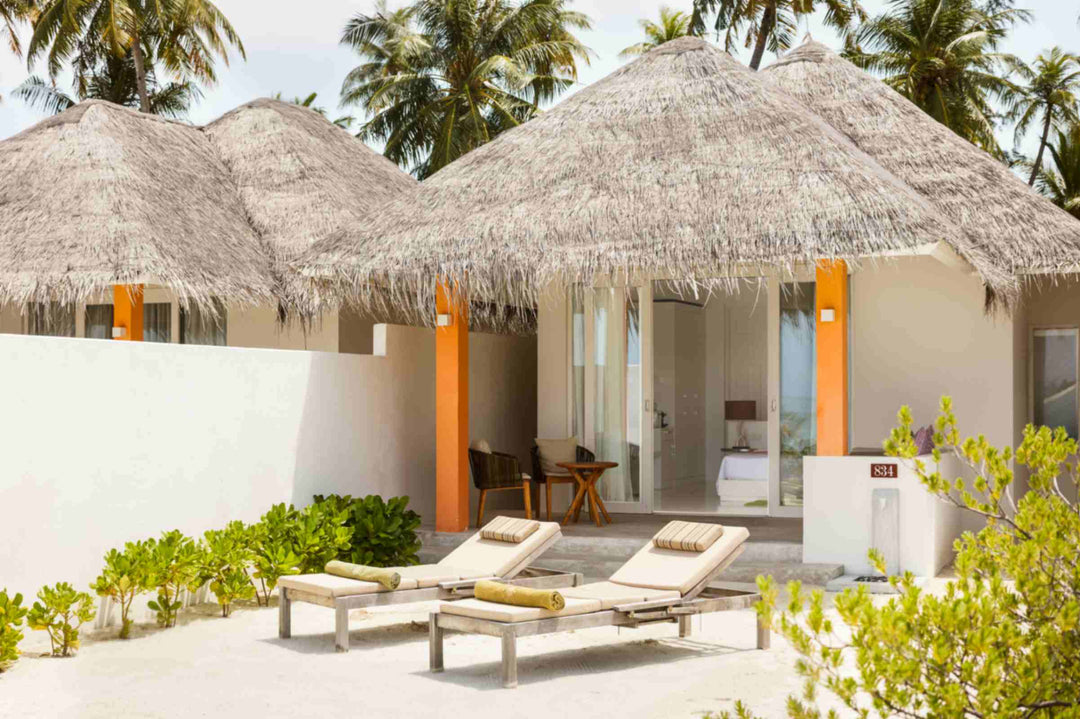 Sun Siyam Olhuveli, South Malé Atoll — thatched beach villas with walled terraces and sun loungers