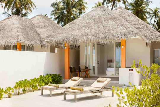 Sun Siyam Olhuveli, South Malé Atoll — thatched beach villas with walled terraces and sun loungers