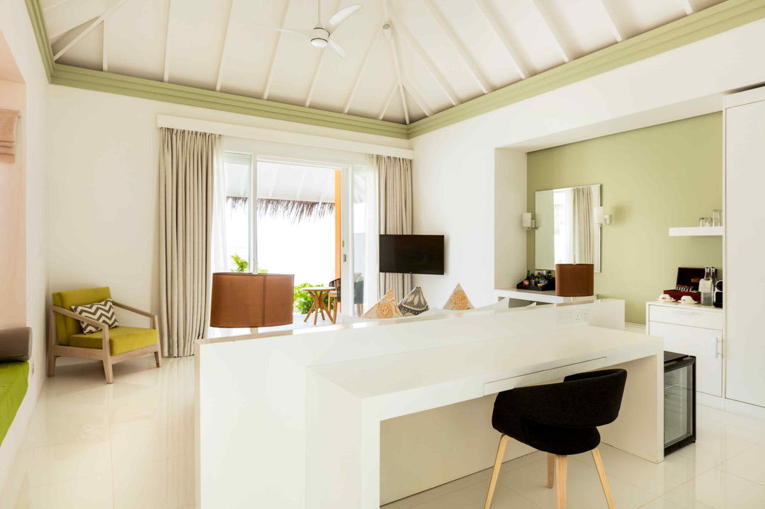 Sun Siyam Olhuveli, South Malé Atoll — desk and dressing area of a beach villa