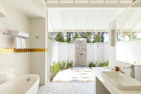 Sun Siyam Olhuveli, South Malé Atoll — beach villa bathroom with a bath and an open-air garden shower