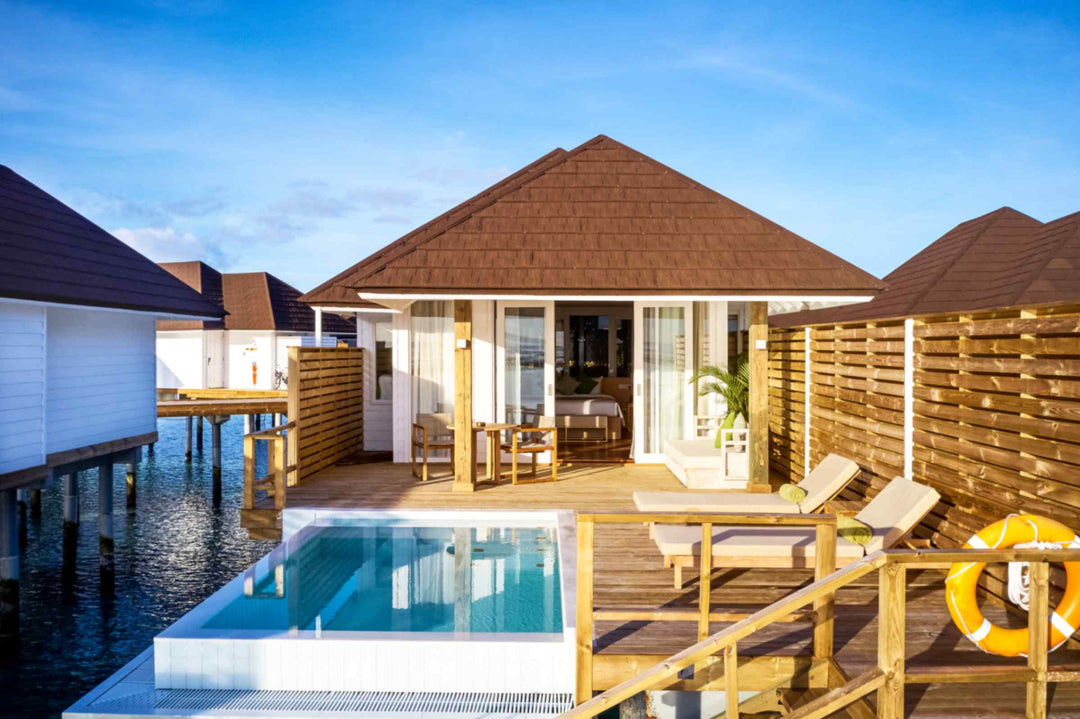 Sun Siyam Olhuveli, South Malé Atoll — overwater villa with a private pool on its deck, seen from the lagoon