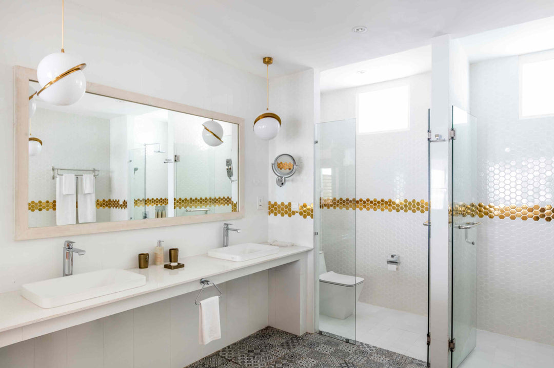 Sun Siyam Olhuveli, South Malé Atoll — twin basins and a walk-in shower in a water villa bathroom