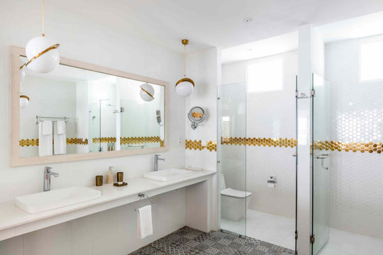 Sun Siyam Olhuveli, South Malé Atoll — twin basins and a walk-in shower in a water villa bathroom