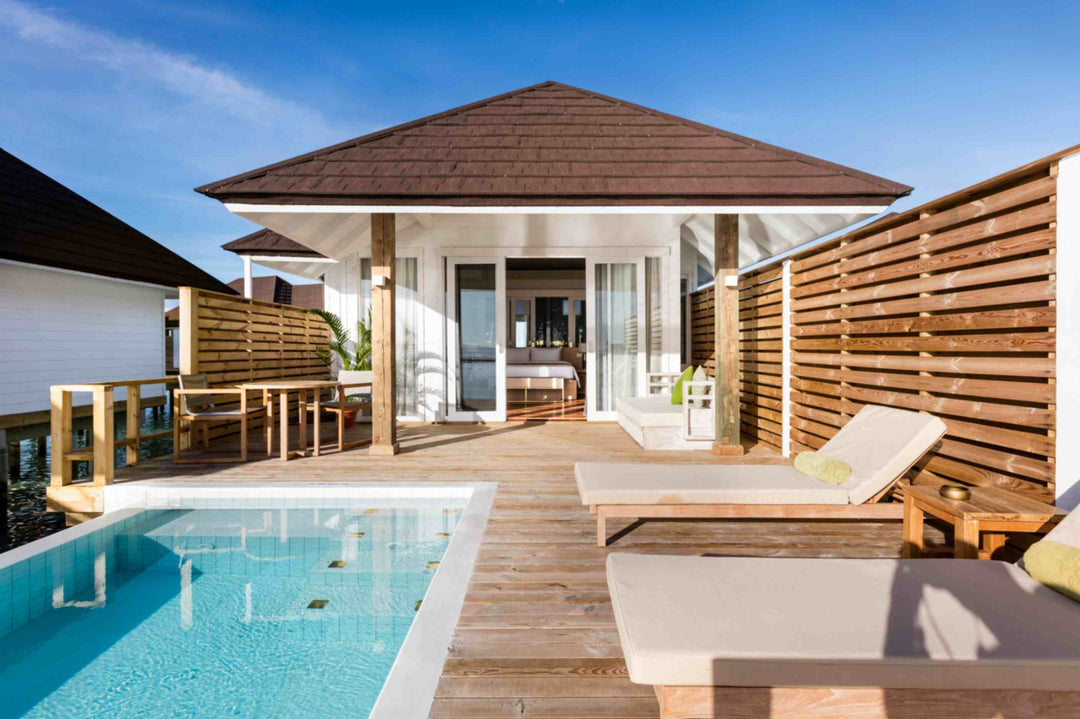 Sun Siyam Olhuveli, South Malé Atoll — overwater villa with a private pool and loungers on the deck