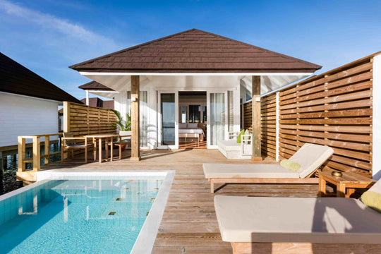 Sun Siyam Olhuveli, South Malé Atoll — overwater villa with a private pool and loungers on the deck