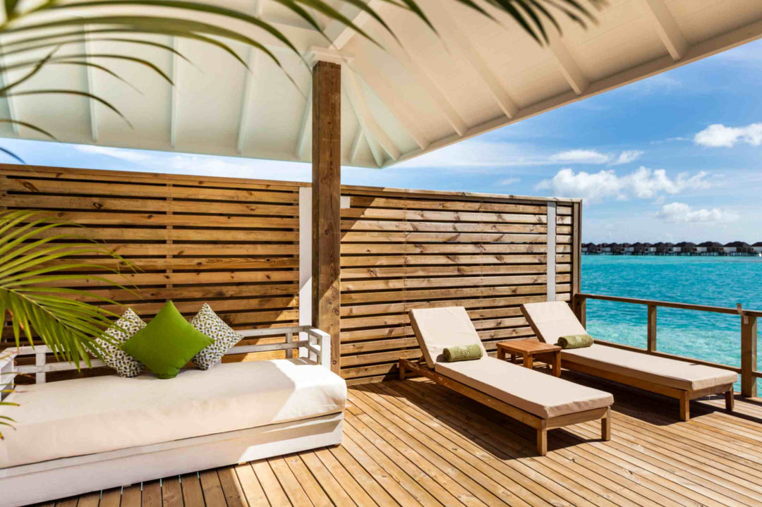 Sun Siyam Olhuveli, South Malé Atoll — daybed and lounger on a screened overwater deck