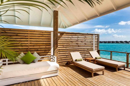 Sun Siyam Olhuveli, South Malé Atoll — daybed and lounger on a screened overwater deck