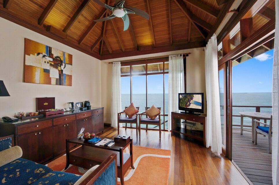 Sun Siyam Olhuveli, South Malé Atoll — Prestige Jacuzzi Water Villa living area with the sea on two sides