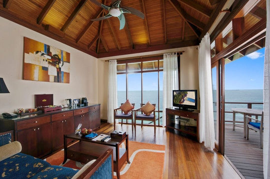 Sun Siyam Olhuveli, South Malé Atoll — Prestige Jacuzzi Water Villa living area with the sea on two sides