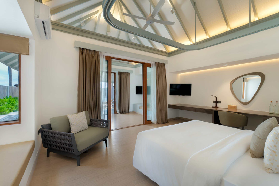 Sun Siyam Olhuveli, South Malé Atoll — Grand Beach Suite with Pool bedroom under a white vaulted ceiling